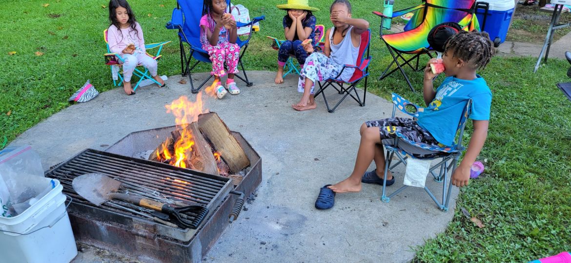 Grandchildren around a fire