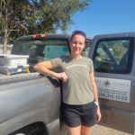 Woman standing against a truck