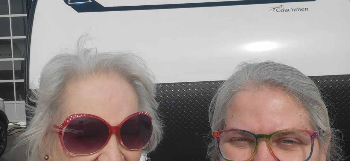 2 women in front of an RV