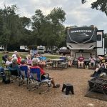 people sitting at a campsite