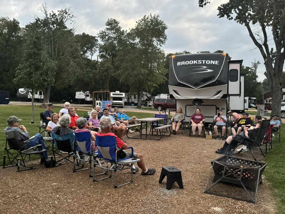 people sitting at a campsite