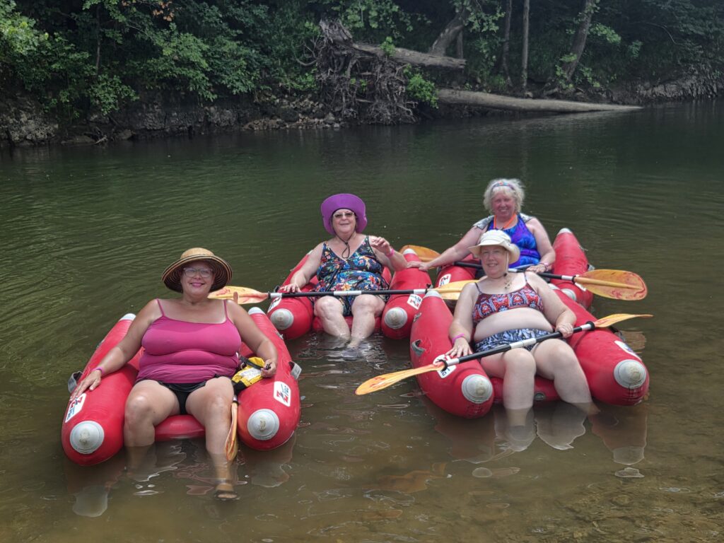 women in floats in the river